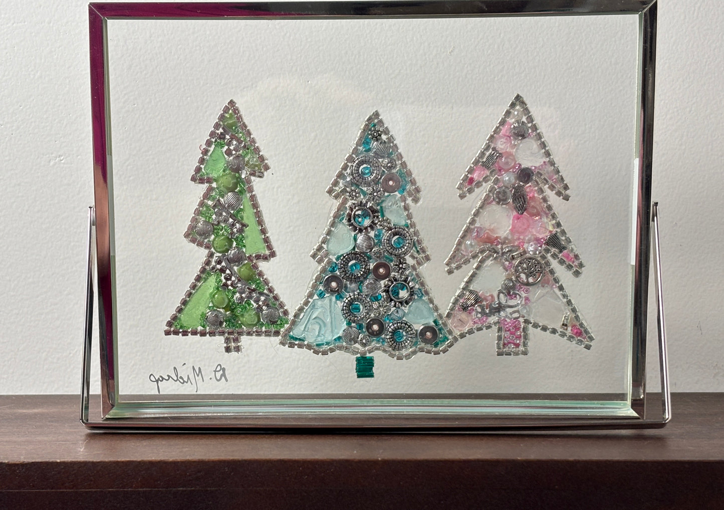 Decorative framed artwork of three stylized trees with colorful embellishments on a white background. Back view.