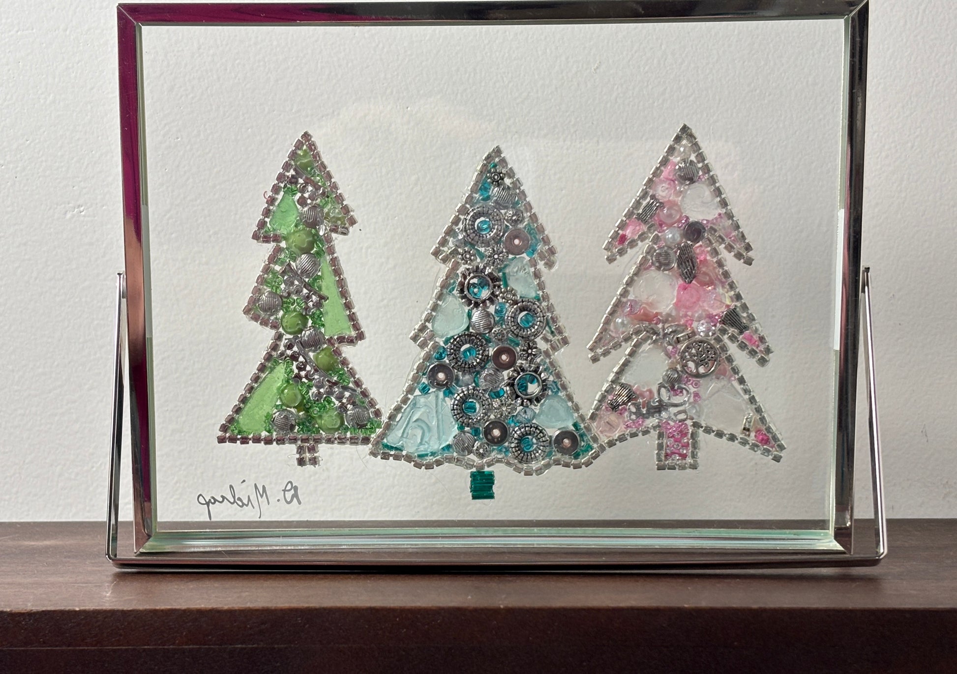 Decorative framed artwork of three stylized trees with colorful embellishments on a white background. Back view.