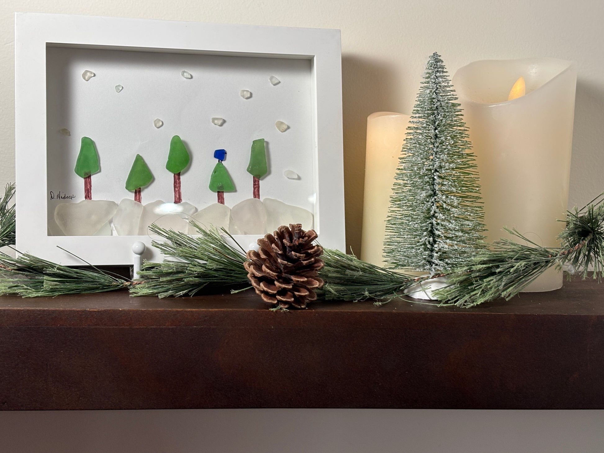 Blue jay sits in forest while snowing. Made from sea glass.