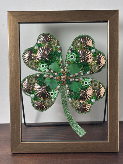 Decorative four-leaf clover with metallic accents and sea glass.